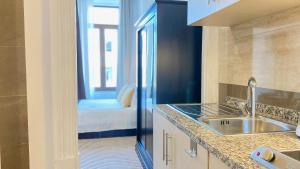 a kitchen with a sink and a bathroom at Gardenia Aparthôtel in Porto