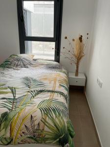 a bedroom with a bed with a plant on it at Sunrise Heights Manilva Costa Del Sol, Andalousie in Manilva