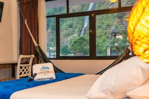 A bed or beds in a room at Hotel De Mi Pueblo