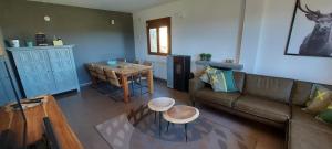 a living room with a couch and a table at La Cabra Trepadora in Neril