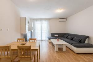 a living room with a couch and a table at Pujanke Residence - large 3 bedroom apartment in Split