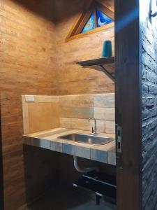 baño con lavabo y pared de madera en EL ZORZAL Dormis con Galeria en Villa del Dique