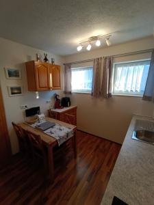 a kitchen with a wooden table and a tableasteryasteryasteryasteryasteryasteryastery at Ferienwohnung Stockenhuber in Sankt Martin am Grimming