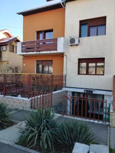 a house with a fence in front of it at Apartament cu 2 dormitoare și terasa Valentin, Iulius Mall in Timişoara