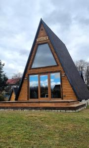 uma cabana de madeira com um telhado de gambrel em Browarówka em Łomnica