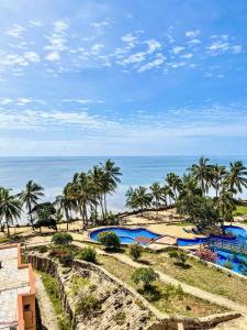 a resort with two pools and the ocean in the background at La Mera Ocean-View, 2 Bedroom - Apartment with Pool and NEW renovated Art Style Rooms in Shanzu