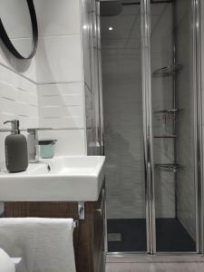 a bathroom with a sink and a shower at El Rincón de Moreno in Munébrega