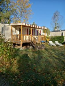 a small house with a porch and a deck at mobil home 32 m² 4/6p in Onzain