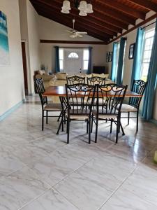 a dining room with a table and chairs at Breezy Apts in Saint Philip