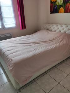 łóżko z białą ramą w sypialni w obiekcie Hardelot plage plein sud a 100 m de la plage w mieście Neufchâtel-Hardelot