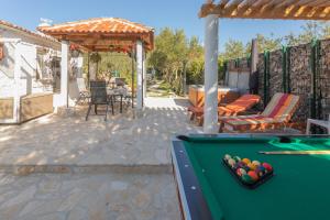 a pool table on a patio with a gazebo at Anica&Jaglica in Brištane