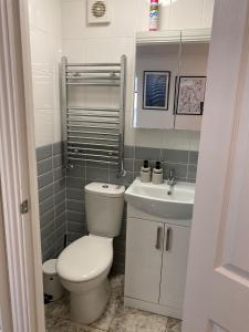 a small bathroom with a toilet and a sink at February Bliss Special, Unwind in Style with Our Exclusive SA PROMO, BOOK NOW in Woolwich