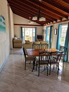 a dining room with a wooden table and chairs at Breezy Apts in Saint Philip