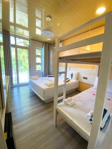 two bunk beds in a room with wooden walls at VIVA Beach Maldives in Hangnaameedhoo +132 photos