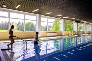 a woman and a child in a swimming pool at App 362 Panoramic Hohegeiß in Braunlage