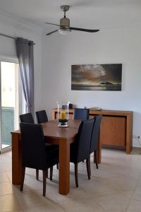 a dining room with a wooden table and chairs at Fairviews Villa on Boavista Golf Resort in Lagos