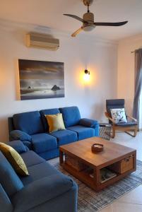 a living room with blue couches and a coffee table at Fairviews Villa on Boavista Golf Resort in Lagos