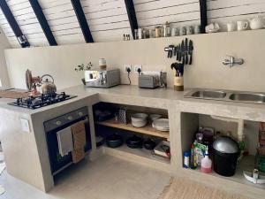 a kitchen with a counter with a stove and a sink at Shepherds Rest in Hoedspruit