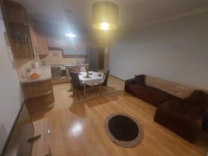 a living room and kitchen with a couch and a table at Apartament Mariacka in Nysa