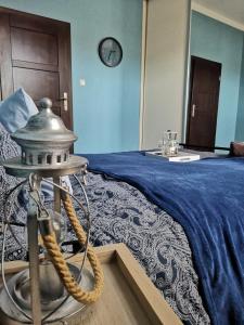 a bedroom with a bed with a sink and a clock at Apartament Mariacka in Nysa