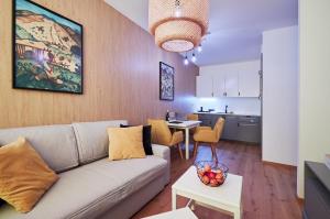 a living room with a couch and a kitchen at RV Apartment Jantár in Vysoke Tatry - Stary Smokovec