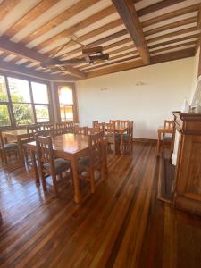 a dining room with a wooden table and chairs at Hostal La Cofa in Viña del Mar