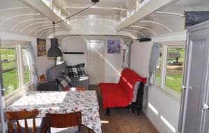 a dining room and kitchen in a tiny house at Gypsy Waggon - A villa on wheels in Amsterdam