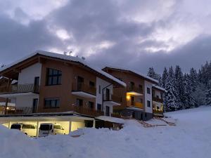 a building with snow in front of it at Moderne Kaminstube in Ramsau am Dachstein