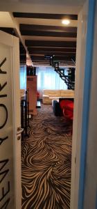 a hallway with a room with a zebra patterned floor at Dvoetažni apartman NEW YORK in Jahorina