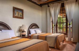 Postel nebo postele na pokoji v ubytování Eco Hotel Ixhi