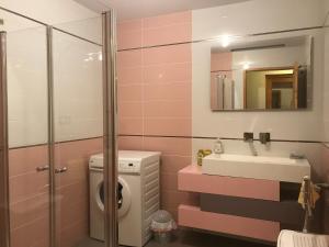 a bathroom with a washing machine and a sink at Gîte "Entre Champsaur et Valgodemard" in Saint-Jacques-en-Valgodemard