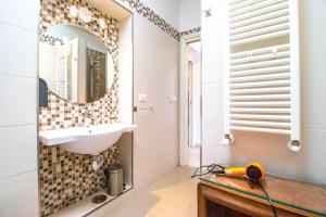 a bathroom with a sink and a mirror at A I R Rettifilo Apartments in Naples +112 photos