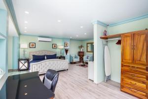 1 dormitorio con 1 cama, escritorio y sillas en Puerto Vallarta South Shore Luxury Suites,, en Puerto Vallarta