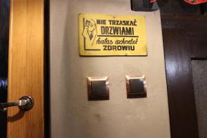 a metal door with a sign on it at PUSTELNIA WODZA in Wisła