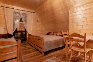a bedroom with a bed with a dog laying on it at PUSTELNIA WODZA in Wisła