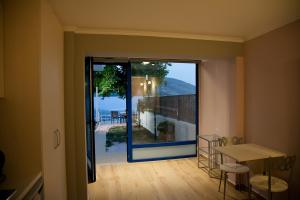 a room with a large glass door leading to a balcony at Villa Niki in Plataria