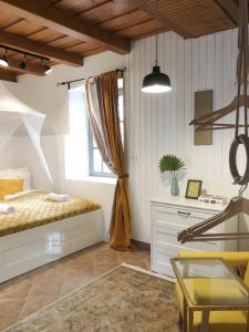 a bedroom with a bed and a chair and a window at 44 George House - Pool, Jacuzzi, Sauna, View in Tilaj +53 photos