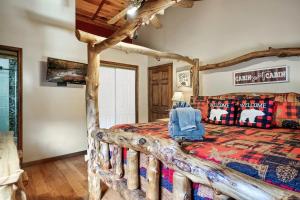a bedroom with a wooden bed with a comforter at Love Shack in Sevierville