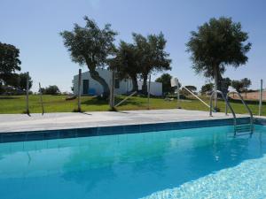 a swimming pool with a slide in front of a house at Casa do Vale da Terra Negra in Vila Nova da Baronia