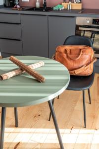 a green table with two baseball bats and a purse at stuub saig in Lenzkirch