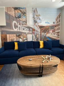 a living room with a blue couch and a coffee table at Trendy West Town Flat - 2 bed / 1.5 bath w parking in Chicago