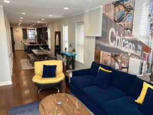 a living room with a blue couch and chairs at Trendy West Town Flat - 2 bed / 1.5 bath w parking in Chicago