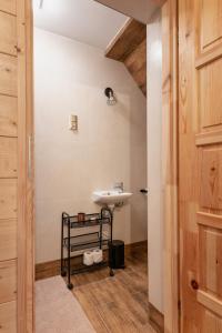 a bathroom with a sink next to a door at PUSTELNIA WODZA in Wisła