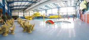 a large room with a playground with a slide at Meadow Lakes 39 in Skegness