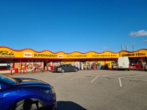 a car parked in a parking lot in front of a store at Meadow Lakes 39 in Skegness