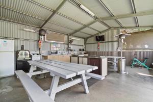 a large kitchen with a picnic table in a building at Traralgon Holiday Village in Traralgon