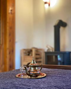 a tea kettle on a table with a glass at Leśny Czar in Serock