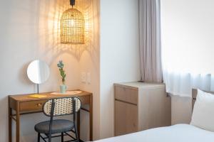 a bedroom with a bed and a desk with a chair at BON Kyoto Kiyomizu in Kyoto