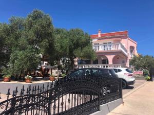 a black wrought iron fence in front of a house at Krk Kornic Apartments in Kornić