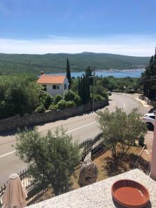 a view from the balcony of a house with a road at Krk Kornic Apartments in Kornić